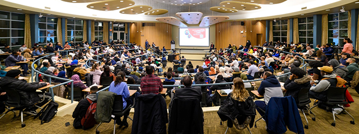 Attendees at Malcolm X Muslim Studies Community Forum sitting in large auditorium